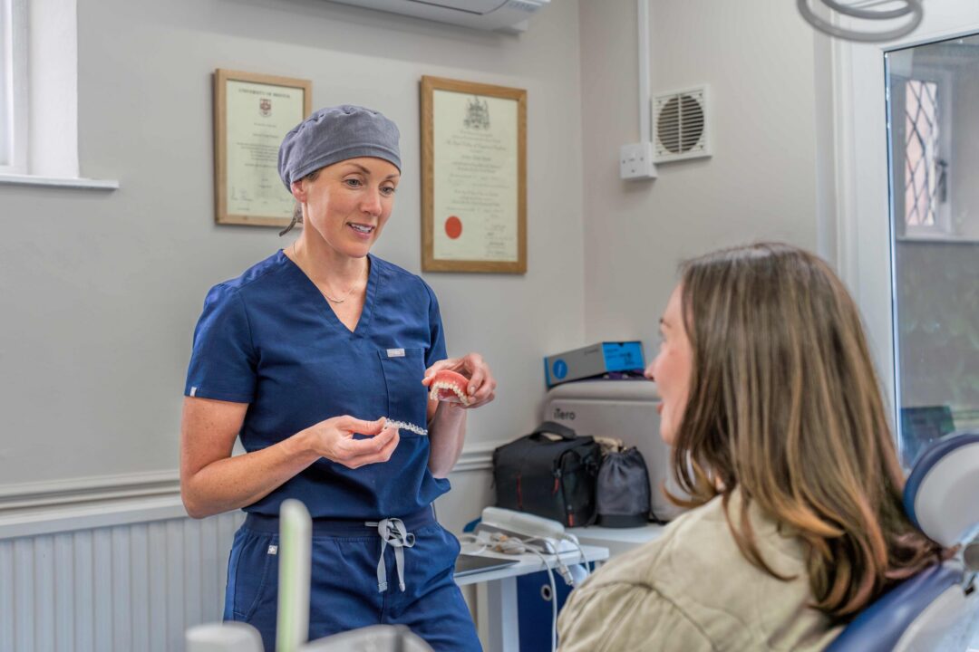 Kate demonstrating Invisalign